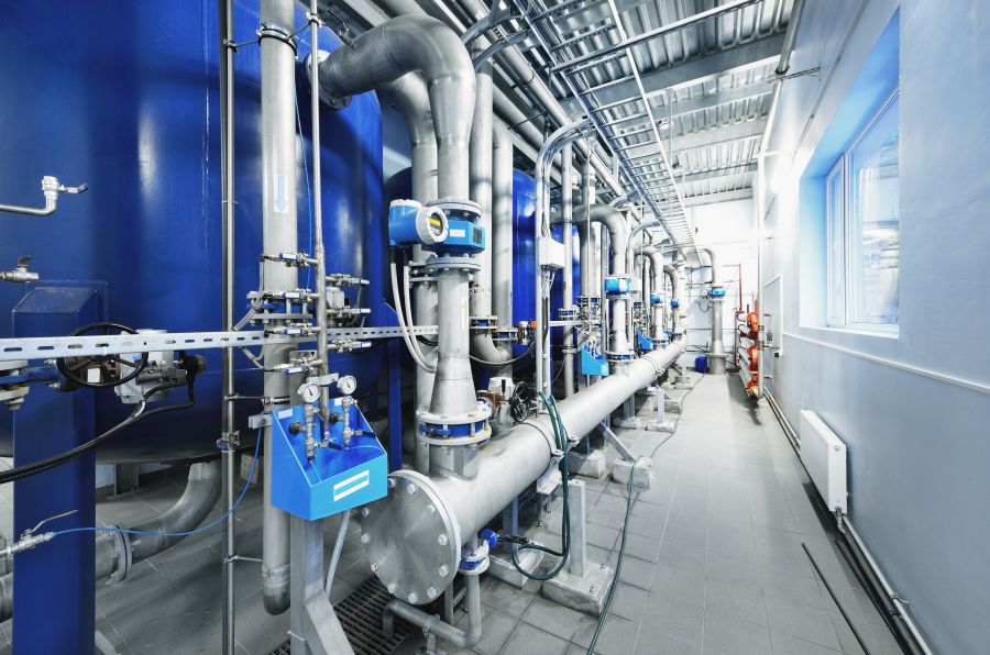 Large blue tanks in a industrial city water treatment boiler roo